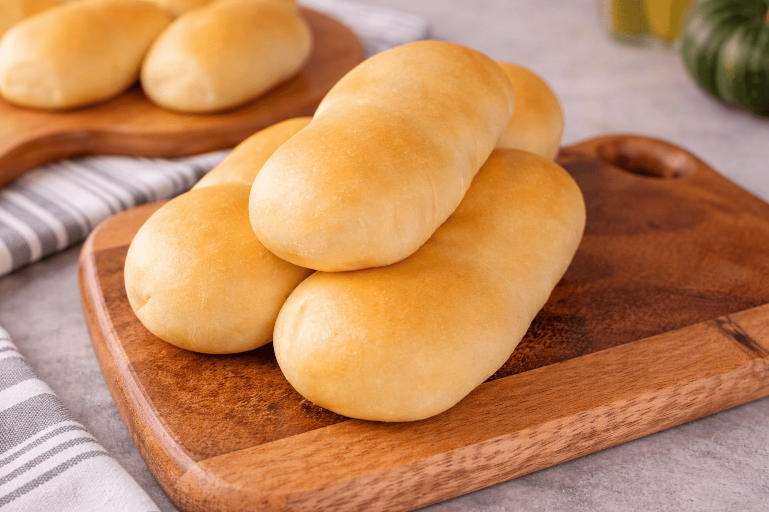 Freshly baked sausage kolaches on a wooden serving board